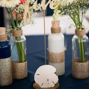 Twine wrapped gold glitter vases for wedding.